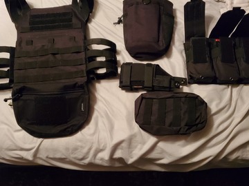 Selling: Black molle vest with loads of attachments 