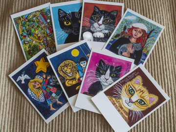 Myydään kirjakauppatavaraa: 2 x 9 kissaa ja 2 leijonaa, postikorttisetti