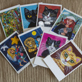 Myydään kirjakauppatavaraa: 9 kissaa ja 2 leijonaa, postikorttisetti