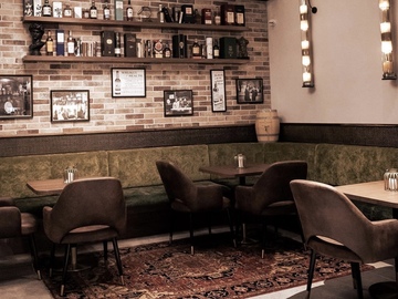 Book a meeting | $: The Whiskey Room | semi-private space looking out to Sarino’s Bar