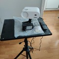 Myydään: Projector with table and screen